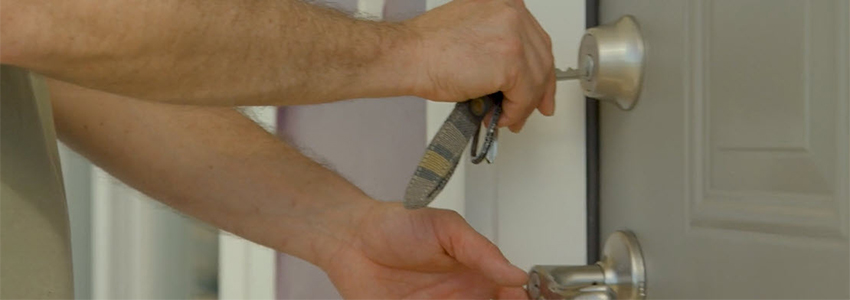 hands with key opening door lock